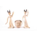 A pair of Chinese pottery dancing maidens, Tang dynasty, with their black painted hair tied in