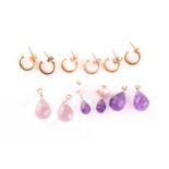 Three pairs of stone set pendant hoop earrings, each composed of a yellow metal hoop, with amethyst,