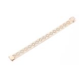 A 9ct yellow gold bracelet, formed of articulated links set with white and rose gold detail, 20 cm