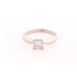 A platinum and diamond ring, set with a square-cut diamond of approximately 0.50 carats, approximate