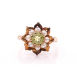 A 9ct yellow gold, peridot, and seed pearl floral cluster ring, ring head 16 mm diameter, size O 1/