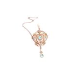 An Edwardian yellow metal, topaz, and split seed pearl pendant, in the Art Nouveau style, set with