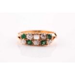 A diamond and emerald chequerboard ring, set with five old brilliant-cut diamonds of approximately
