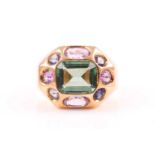 An unusual yellow metal, tourmaline, and amethyst cocktail ring, set with a mixed rectangular-cut