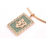 A yellow metal mounted green jade pendant, the square jade plaque bearing gold decoration of a