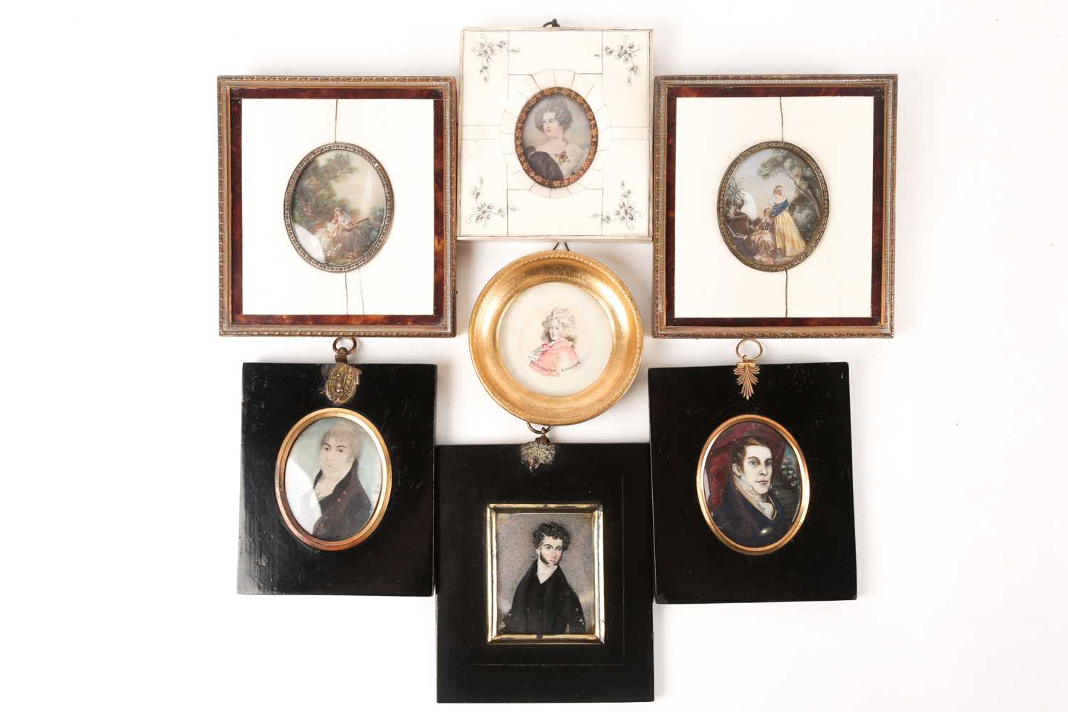 Three 19th century portrait miniatures on ivory of young gentlemen, each in black lacquered frame, a