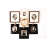 Three 19th century portrait miniatures on ivory of young gentlemen, each in black lacquered frame, a