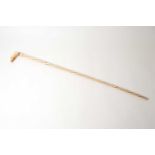 A large worked bone walking stick, 19th century, possibly whalebone, the ivory grip in the form of a