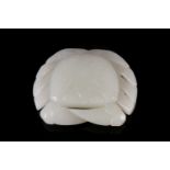 A Chinese white jade carved crab pendant, 20th century, the shell carved with a hatched lozenge