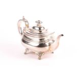 A late Georgian silver teapot, marks rubbed, with scroll handle on lion paw feet, 17.5 cm high x