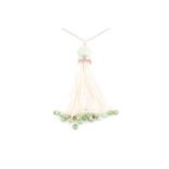 An Art Deco jade and seed pearl tassel pendant necklace, set with a rounded jade bead suspended with