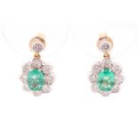 A pair of diamond and emerald cluster drop earrings, each set with a mixed oval-cut emerald within a