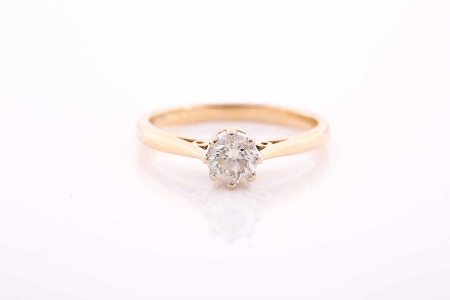 An 18ct yellow gold and solitaire diamond ring, set with a round brilliant-cut diamond of