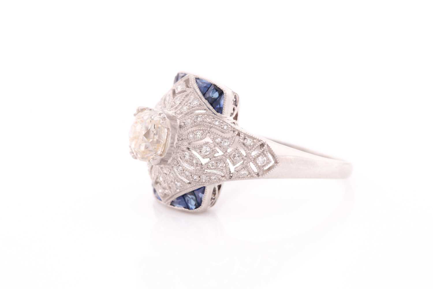 An unusual diamond and sapphire ring, in the Art Deco style, centred with an old cushion-cut - Image 2 of 5