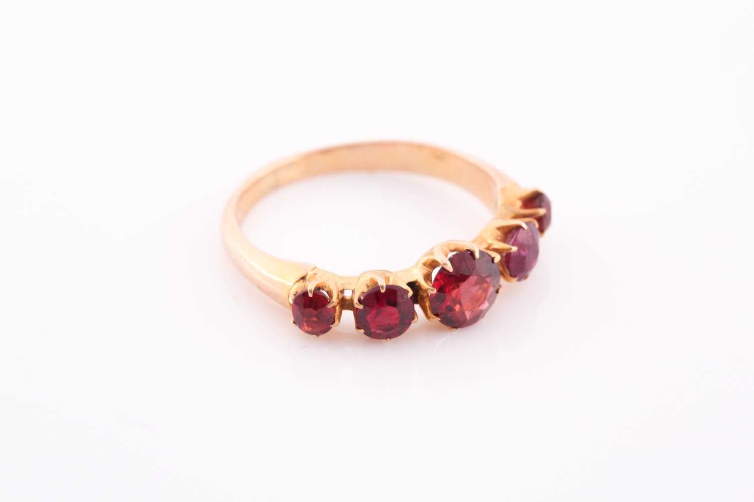 A yellow metal and garnet ring, the five round-cut garnets individually claw-set, yellow metal - Image 4 of 5