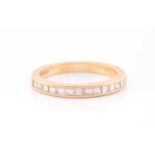 An 18ct yellow gold and diamond half-eternity ring the band calibre set with fourteen princess cut