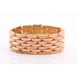 A 14ct yellow and rose gold articulated brick-link bracelet, set with alternating rows of rose and