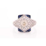 An unusual diamond and sapphire ring, in the Art Deco style, centred with an old cushion-cut