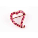 A yellow metal and red spinel heart-shaped brooch, set with mixed-cut red spinels, unmarked, 2.2 x
