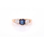 A late 19th / early 20th century diamond and sapphire ring, the carved mount centred with a mixed