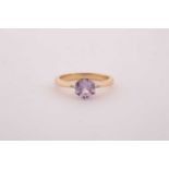 An 18ct yellow gold and solitaire sapphire ring, set with a mixed round-cut pink sapphire,