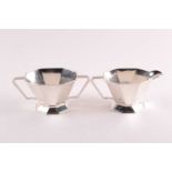 An Art Deco silver cream jug and sugar bowl, Birmingham 1937 by Adie Brothers; of panelled octagonal