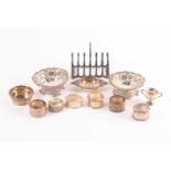 A mixed group of small silver items, comprising a toast rack, a pair of heart-shaped dishes with