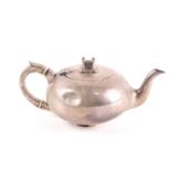An Edwardian silver teapot, Dublin 1902 by West and Son, of bullet form with a stylised castle