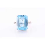 A platinum, blue topaz and diamond dress ring, set with a mixed rectangular-cut topaz, of