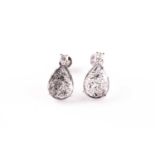 A pair of diamond earrings, each set with a mixed pear-cut polki diamond, with salt and pepper