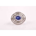 A silver, diamond, and tanzanite ring, set east to west with a mixed oval-cut tanzanite of