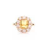 An 18ct yellow gold, diamond, and yellow sapphire dress ring, set with an emerald-cut sapphire of