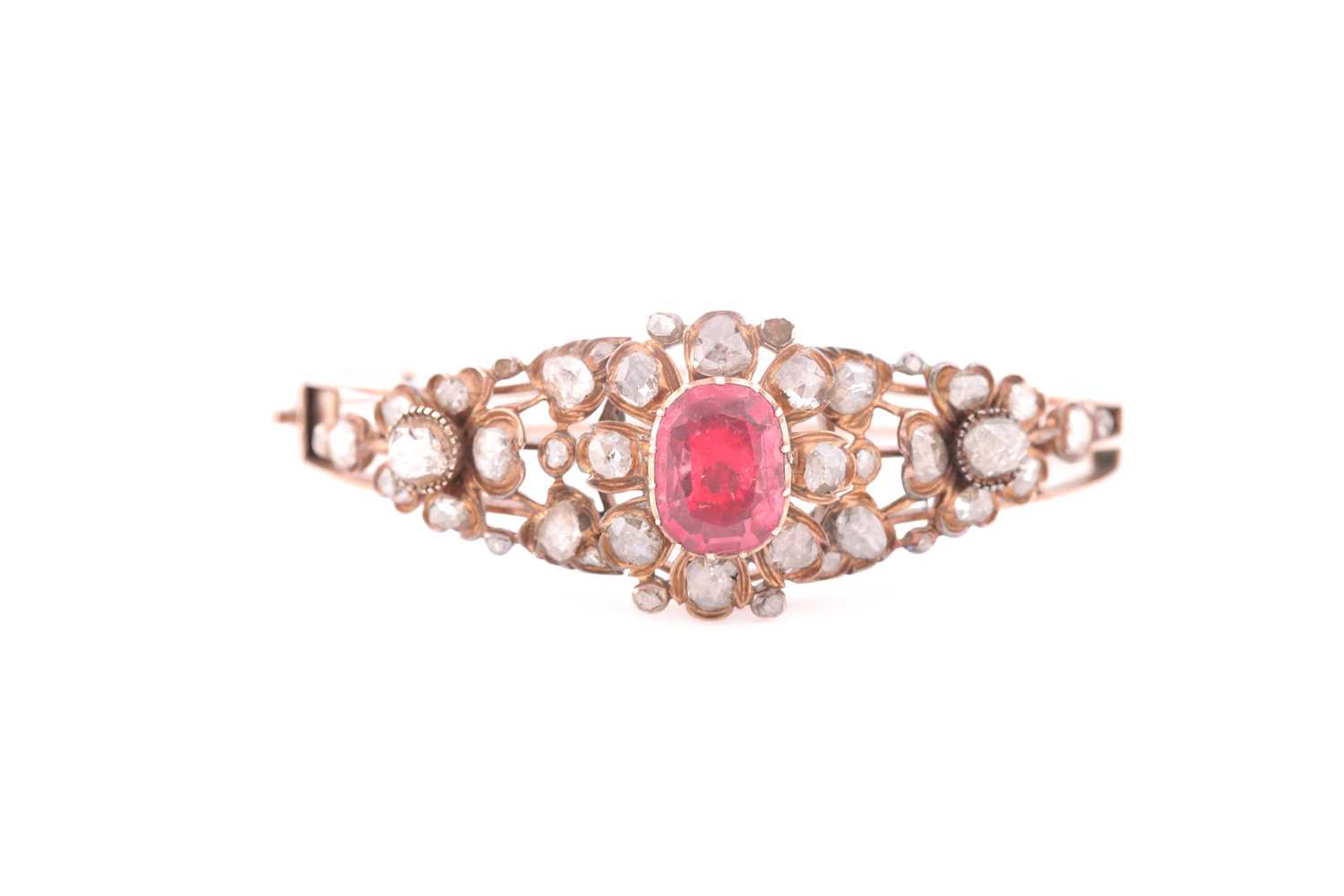 An antique yellow metal and diamond bangle, set with a reddish pink central stone, likely spinel, - Image 2 of 6