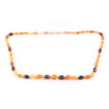 An amber bead necklace, comprising of butterscotch and dark and light amber beads, largest