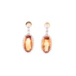 A pair of yellow metal, diamond, and citrine drop earrings, set with mixed oval-cut orange