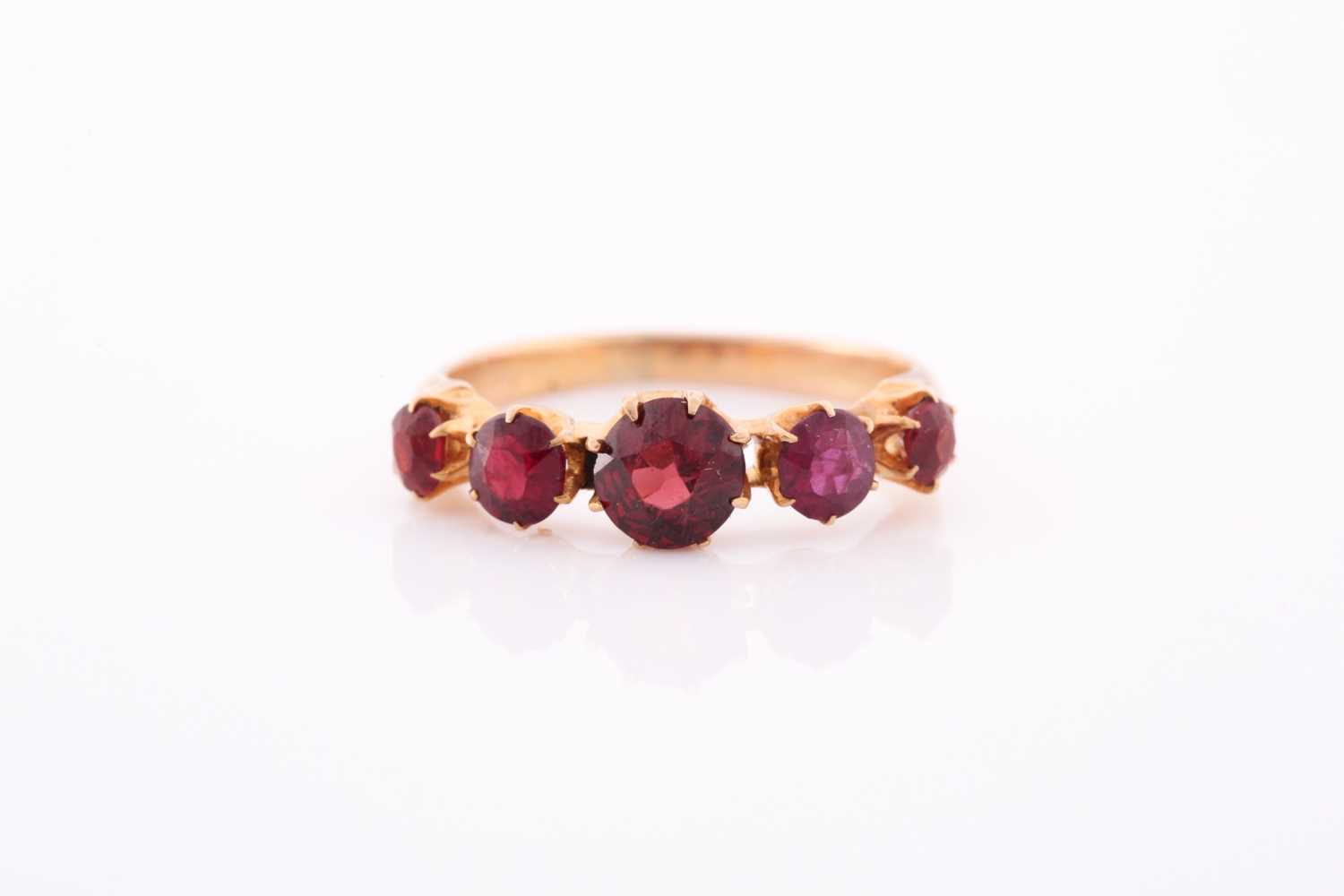 A yellow metal and garnet ring, the five round-cut garnets individually claw-set, yellow metal - Image 5 of 5