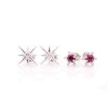 A pair of diamond and ruby earrings, of floral design, each centred with a round-cut ruby