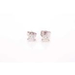 A pair of solitaire diamond stud earrings, set with round brilliant-cut diamonds of approximately
