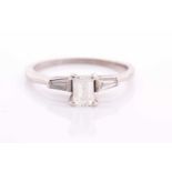 An 18ct white gold and diamond ring, set with an emerald-cut diamond of approximately 0.60 carats,