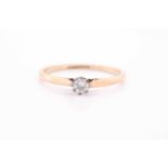 A single stone synhetic corundum dress ring; the circular cut stone in six claw setting and heart-