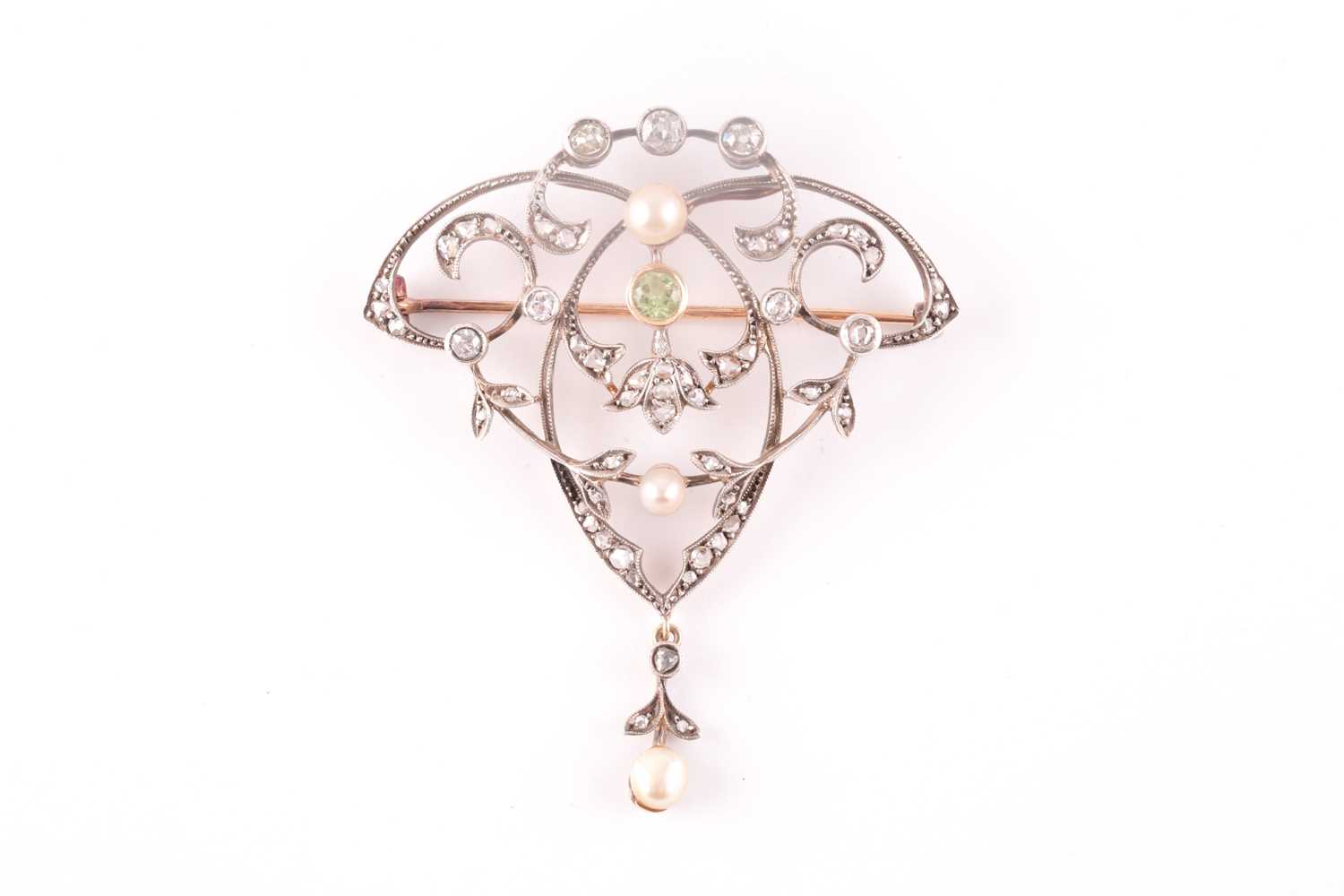 A yellow and white metal, peridot, diamond and pearl brooch/pendant, the openwork art Nouveau