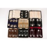 A collection of cased tea/coffee spoons and sugar bows. Including Sheffield 1918 by Mappin & Webb