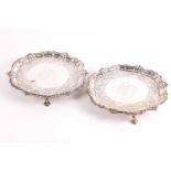 A pair of mid 18th century salvers - apparently unmarked - probably Irish; each shaped circular with