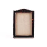 A silver mounted tortoiseshell photograph frame; Birmingham 1926 by Adie Brothers; arched
