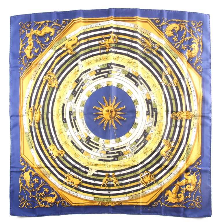 Hermes, Paris. A polychrome zodiac scarf, with dark blue border, together with a Hermes scarf with