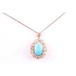A diamond and turquoise cluster pendant, set with an oval turquoise plaque, surrounded with old-