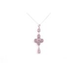 An 18ct white gold, diamond, and pink sapphire quatrefoil drop pendant necklace, the cross design