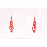 A pair of yellow metal and coral beaded earrings, the coral beads strung into two strands,