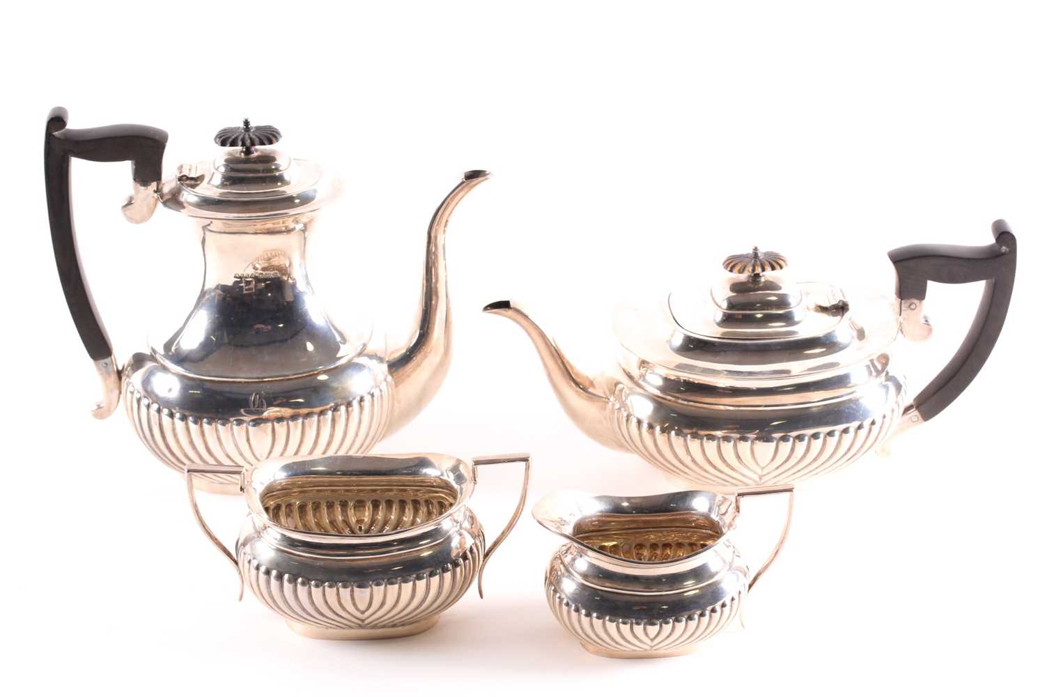 An Edward VII four-piece silver tea set, Sheffield 1904 by 'W. & E. V.', comprising a teapot, hot