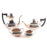 An Edward VII four-piece silver tea set, Sheffield 1904 by 'W. & E. V.', comprising a teapot, hot